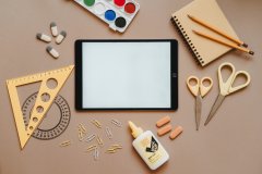 School Supplies and iPad on beige background